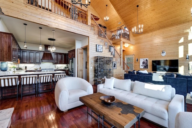 living room featuring wooden walls, high vaulted ceiling, a chandelier, dark wood-type flooring, and wooden ceiling