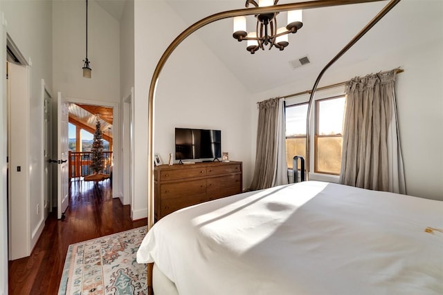 bedroom featuring high vaulted ceiling, dark hardwood / wood-style floors, and a chandelier