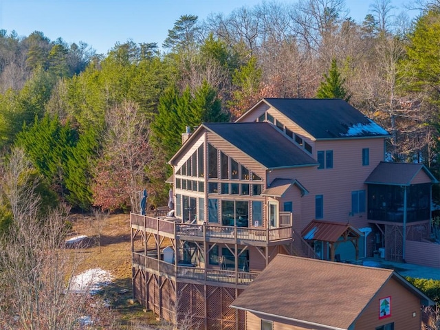 back of house featuring a deck and a sunroom