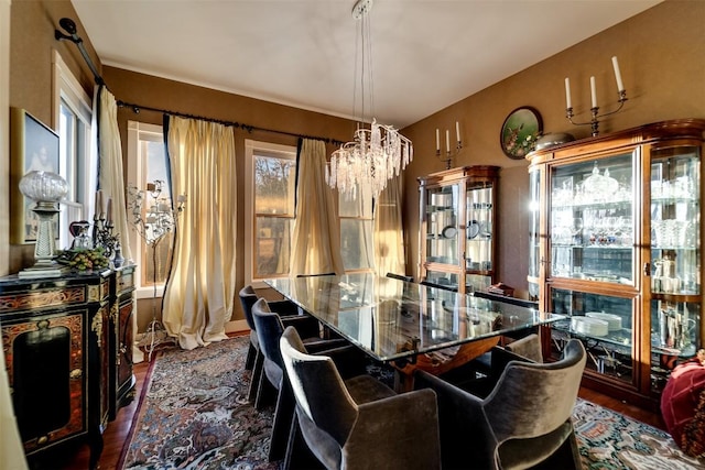 dining room with an inviting chandelier and dark hardwood / wood-style floors