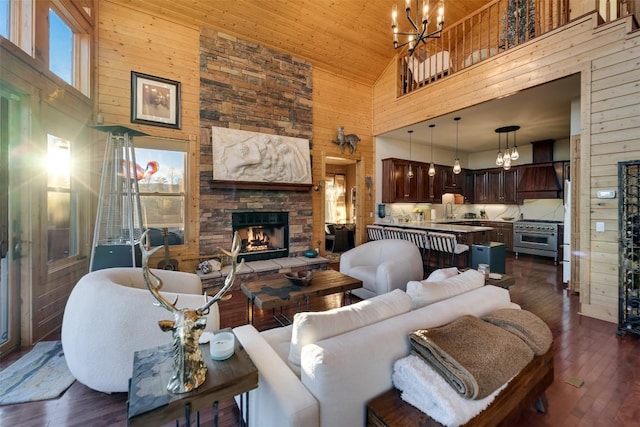 living room featuring dark wood-type flooring, a fireplace, and high vaulted ceiling