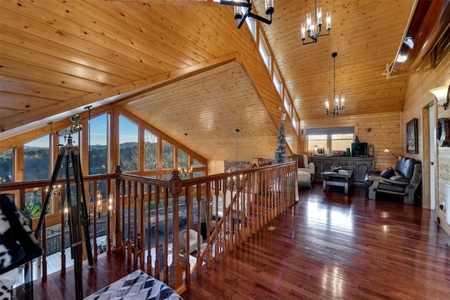 corridor with high vaulted ceiling, dark hardwood / wood-style floors, wooden ceiling, and an inviting chandelier