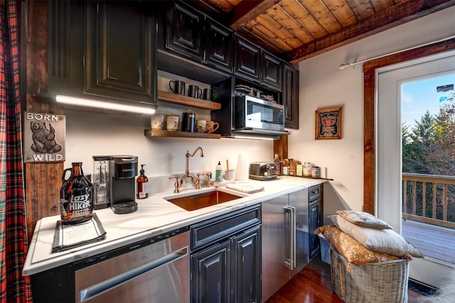 kitchen with sink, dark wood-type flooring, wooden ceiling, and appliances with stainless steel finishes