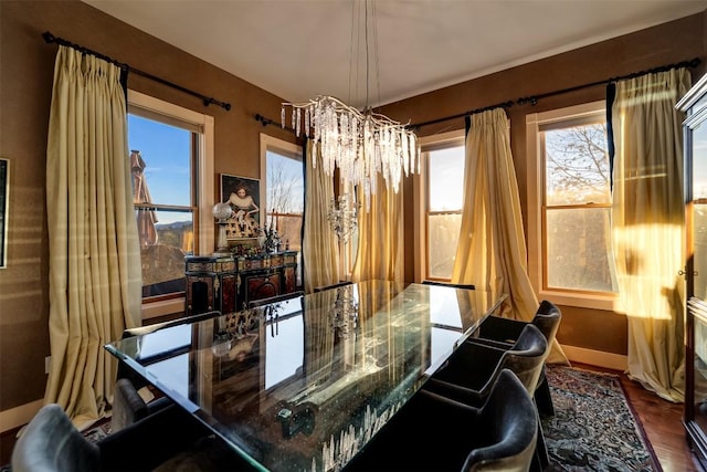 dining area featuring hardwood / wood-style floors and a chandelier