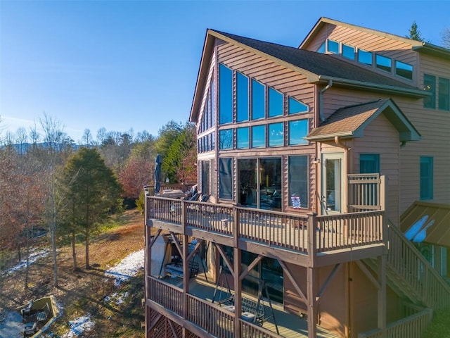 rear view of house with a wooden deck