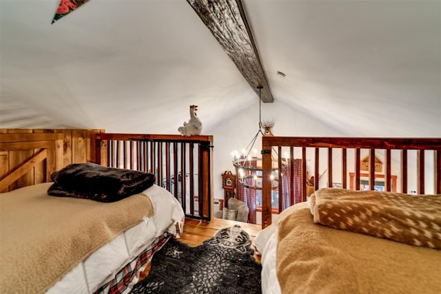 bedroom with a chandelier, hardwood / wood-style floors, and vaulted ceiling with beams