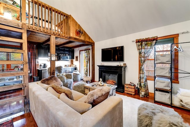 living room featuring hardwood / wood-style flooring and lofted ceiling