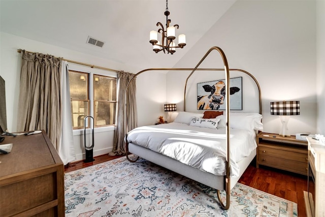 bedroom with lofted ceiling, a notable chandelier, and dark hardwood / wood-style floors