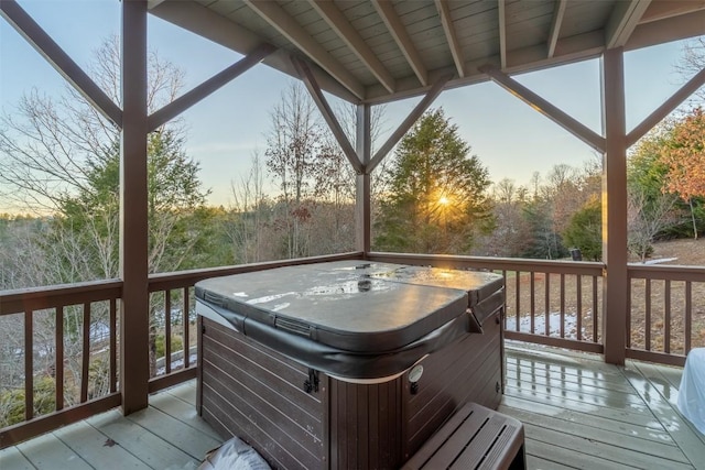 deck at dusk with a hot tub