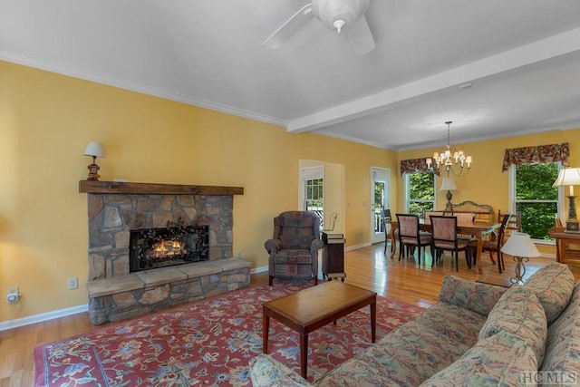 living room featuring a healthy amount of sunlight, wood-type flooring, and a fireplace