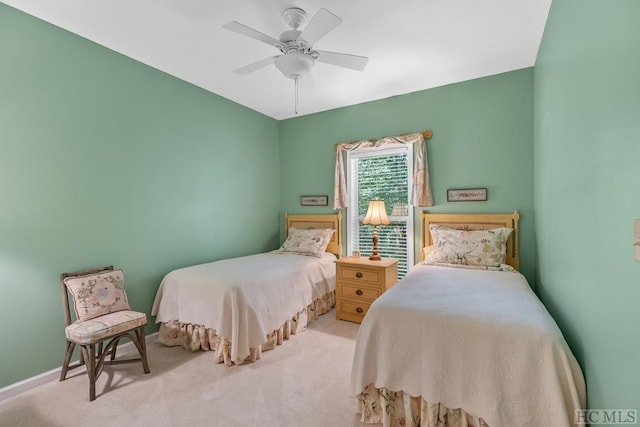 bedroom featuring light carpet and ceiling fan