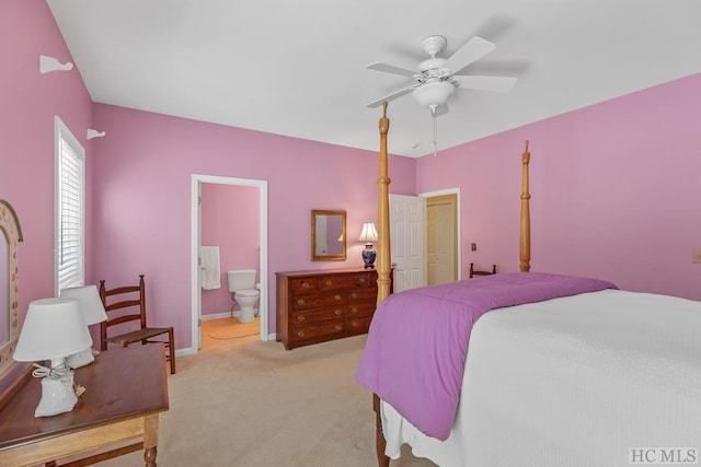 carpeted bedroom featuring ceiling fan and ensuite bathroom