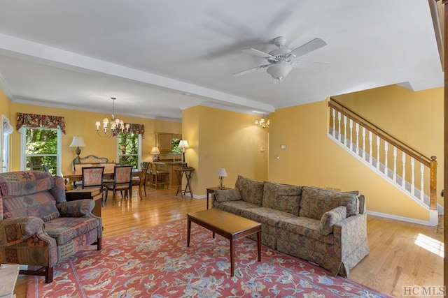 living room with beamed ceiling, ceiling fan with notable chandelier, and light wood-type flooring