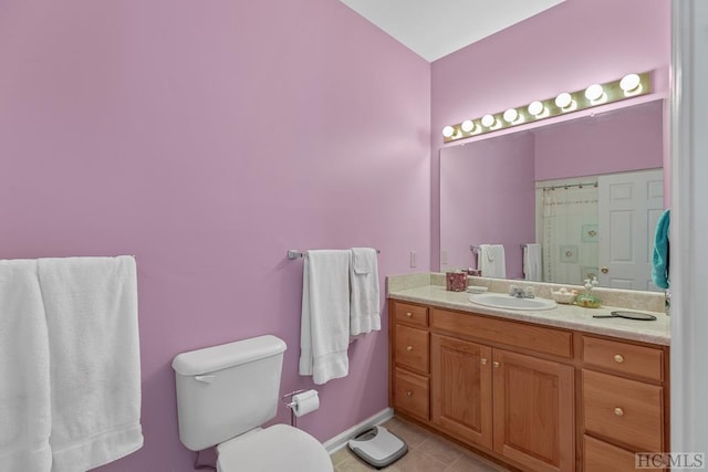 bathroom featuring tile patterned flooring, vanity, and toilet