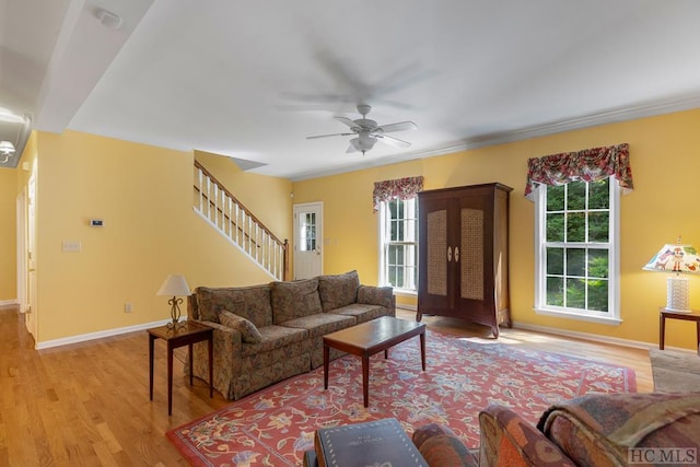 living room featuring light hardwood / wood-style flooring and ceiling fan