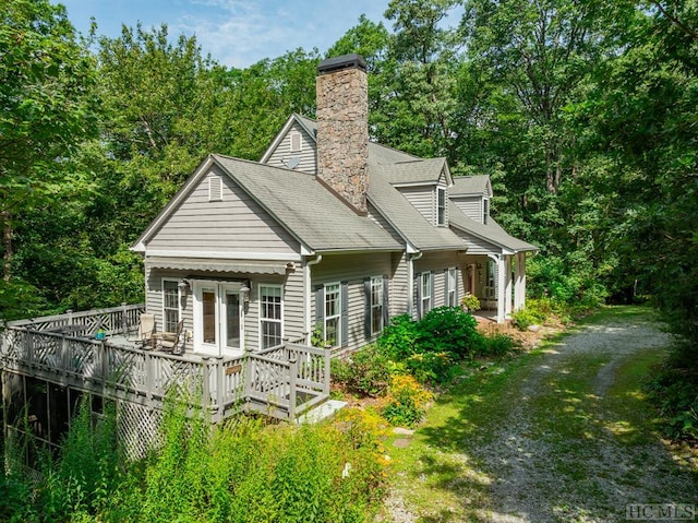 back of property featuring a wooden deck