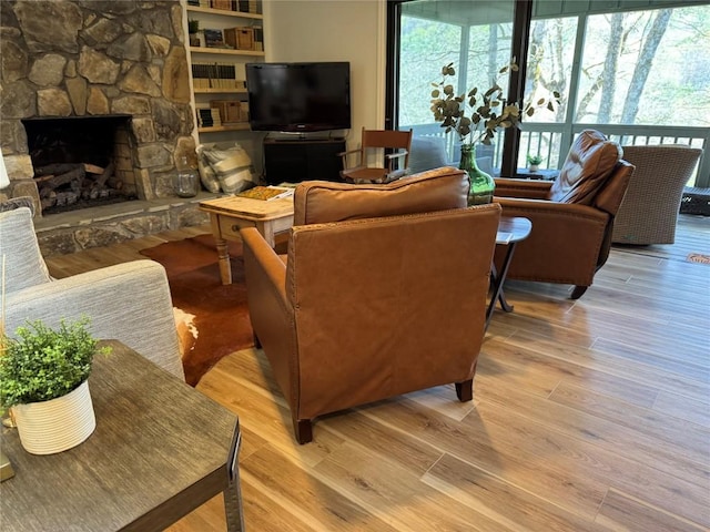 living room with wood finished floors and a fireplace