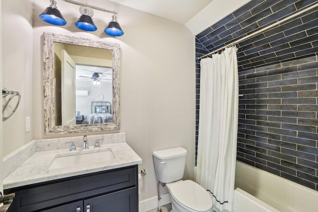 ensuite bathroom with toilet, vanity, a ceiling fan, and shower / tub combo
