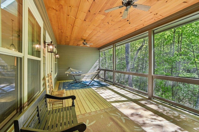 unfurnished sunroom with a ceiling fan and healthy amount of natural light