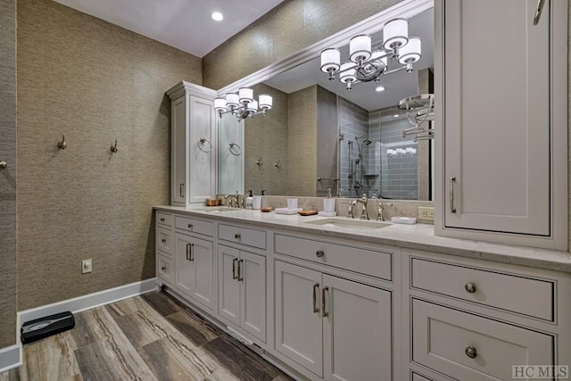 bathroom with walk in shower, wood-type flooring, and vanity