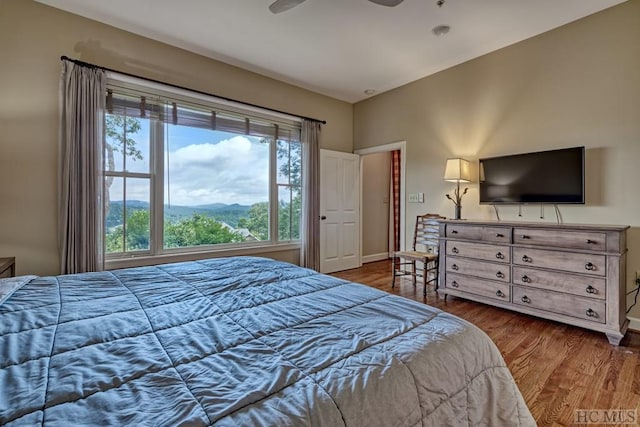 bedroom featuring ceiling fan and dark hardwood / wood-style floors