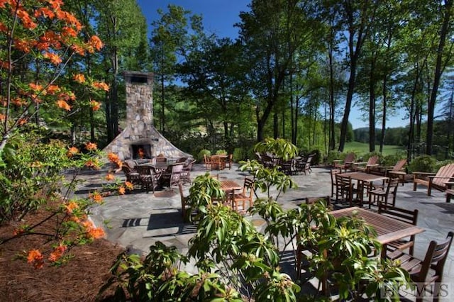 view of patio featuring an outdoor stone fireplace