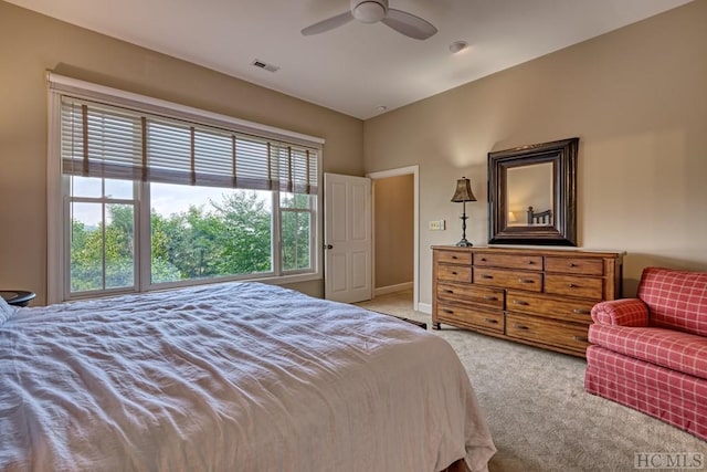 bedroom featuring light colored carpet and ceiling fan