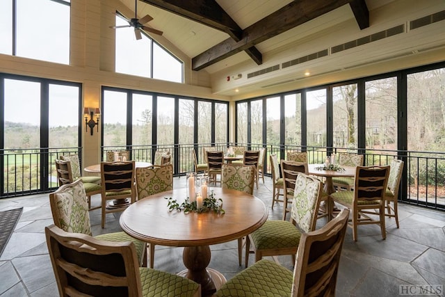 sunroom with lofted ceiling with beams and ceiling fan