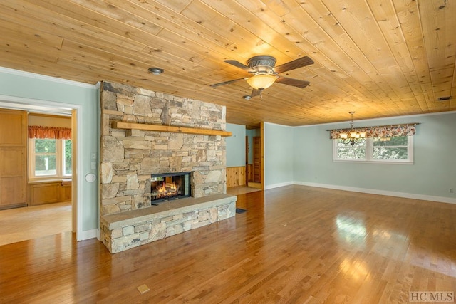 unfurnished living room featuring wooden ceiling, ornamental molding, wood finished floors, and a stone fireplace