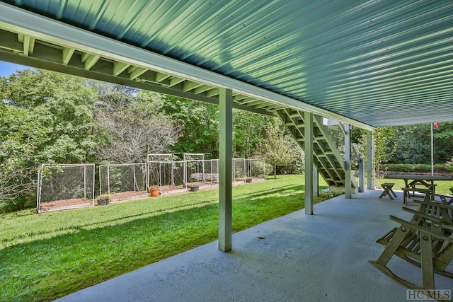 view of patio with stairway and fence