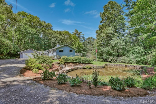 exterior space with a garage and an outbuilding