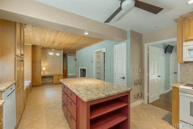 kitchen with light stone counters, a center island, hanging light fixtures, decorative backsplash, and white appliances