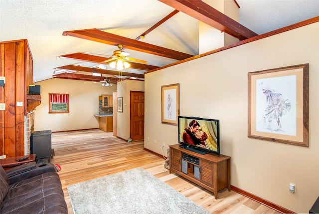 living area with a ceiling fan, light wood finished floors, and baseboards