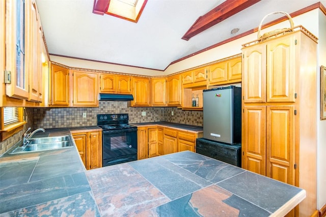 kitchen with black range with electric stovetop, a sink, freestanding refrigerator, under cabinet range hood, and decorative backsplash