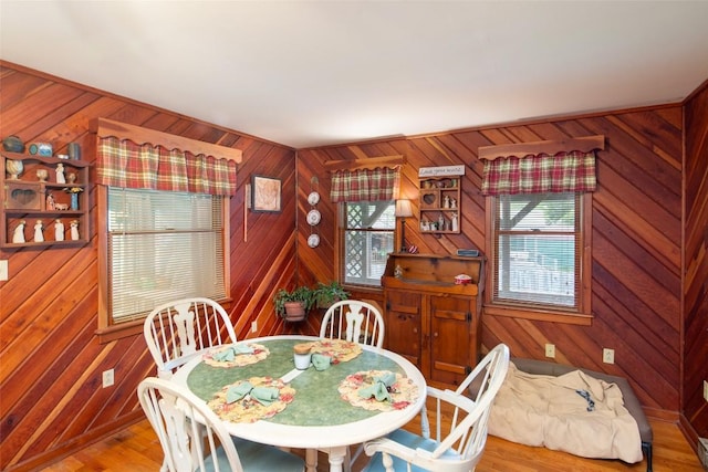 dining room featuring wood walls and wood finished floors