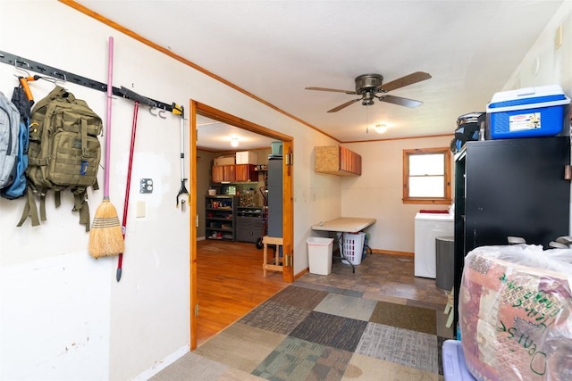washroom featuring washer / dryer, a ceiling fan, baseboards, wood finished floors, and crown molding