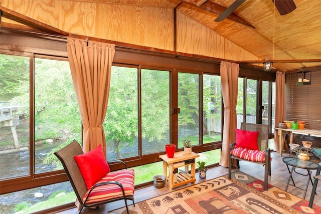 sunroom / solarium with lofted ceiling, wooden ceiling, and wooden walls
