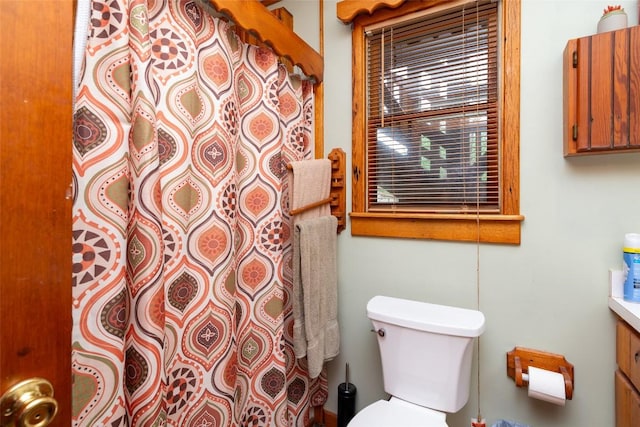 bathroom with vanity, toilet, and a shower with shower curtain