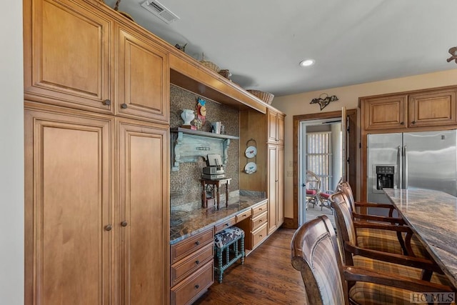 kitchen featuring stainless steel fridge with ice dispenser and dark wood-type flooring