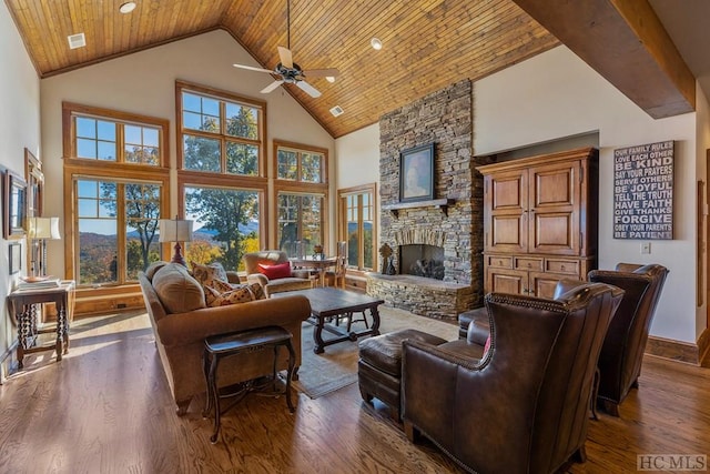 living room featuring wood ceiling, dark hardwood / wood-style floors, high vaulted ceiling, and a stone fireplace