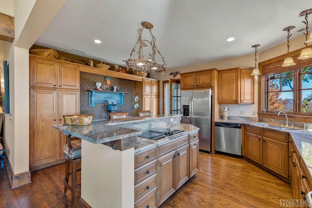 kitchen with pendant lighting, stainless steel appliances, a breakfast bar, and a center island