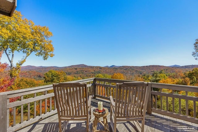 wooden deck with a mountain view