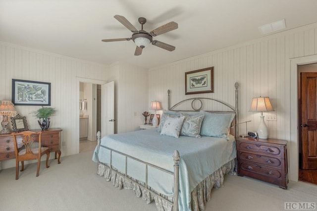 carpeted bedroom featuring connected bathroom and ceiling fan