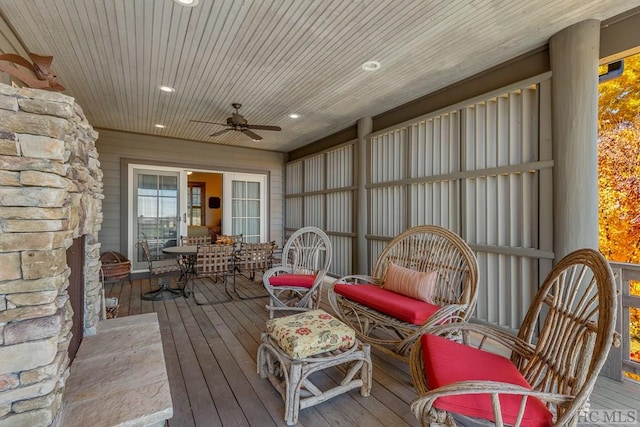 sunroom / solarium featuring ceiling fan and wooden ceiling