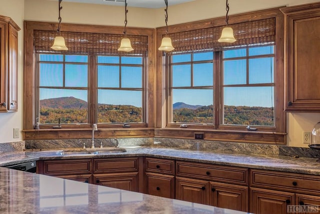 kitchen featuring dishwasher, a mountain view, sink, and decorative light fixtures