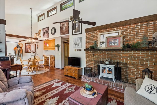 38 Lonely Mountain Dr Unit 24-A, Sapphire, NC 28774 - living room with wood finished floors, a ceiling fan, a chandelier, a high ceiling, and a wall unit AC