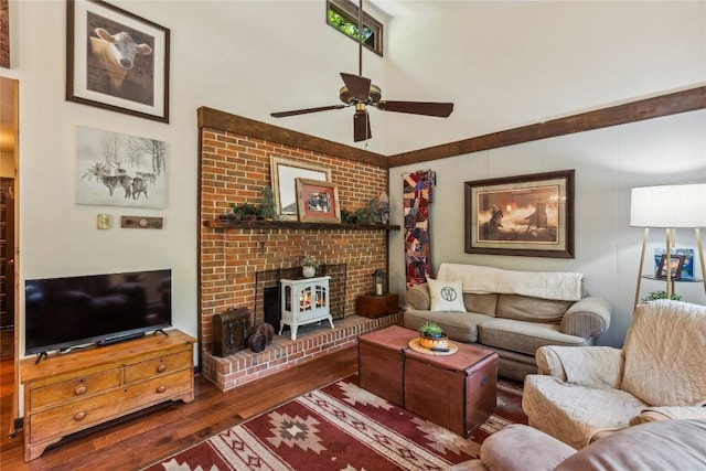 38 Lonely Mountain Dr Unit 24-A, Sapphire, NC 28774 - living area with wood finished floors, a ceiling fan, a high ceiling, and a wood stove