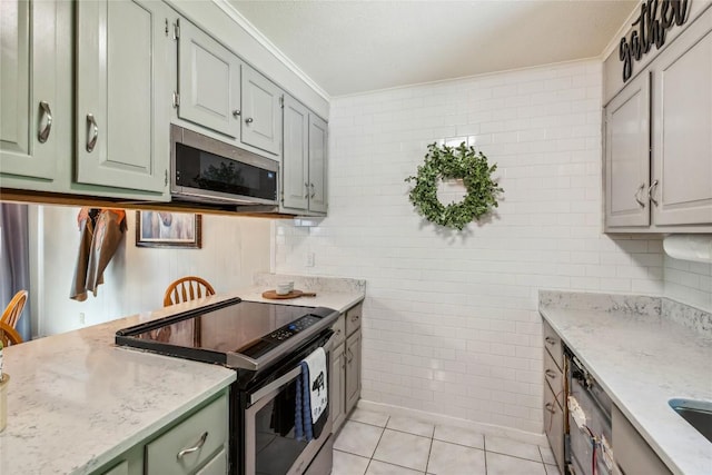 38 Lonely Mountain Dr Unit 24-A, Sapphire, NC 28774 - kitchen with electric range, stainless steel microwave, tile walls, crown molding, and light tile patterned floors