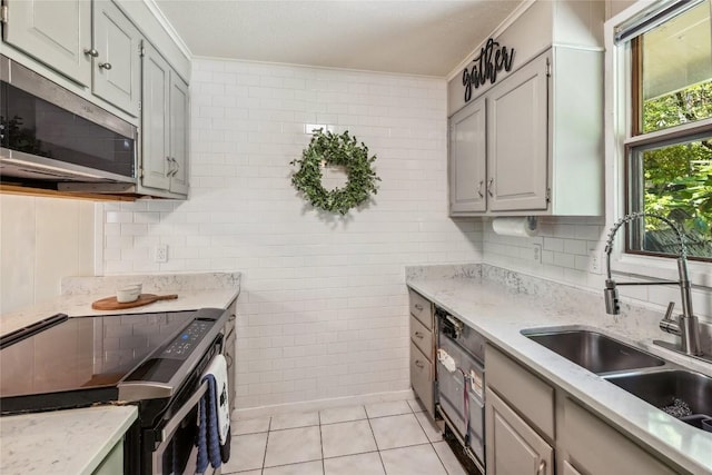38 Lonely Mountain Dr Unit 24-A, Sapphire, NC 28774 - kitchen with black range with electric cooktop, stainless steel microwave, light tile patterned floors, crown molding, and light stone countertops