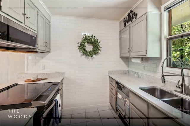 38 Lonely Mountain Dr Unit 24-A, Sapphire, NC 28774 - kitchen featuring black range with electric stovetop, stainless steel microwave, dark tile patterned floors, light stone countertops, and tile walls